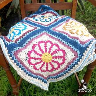 Bold summer flower in center of granny blanket squares