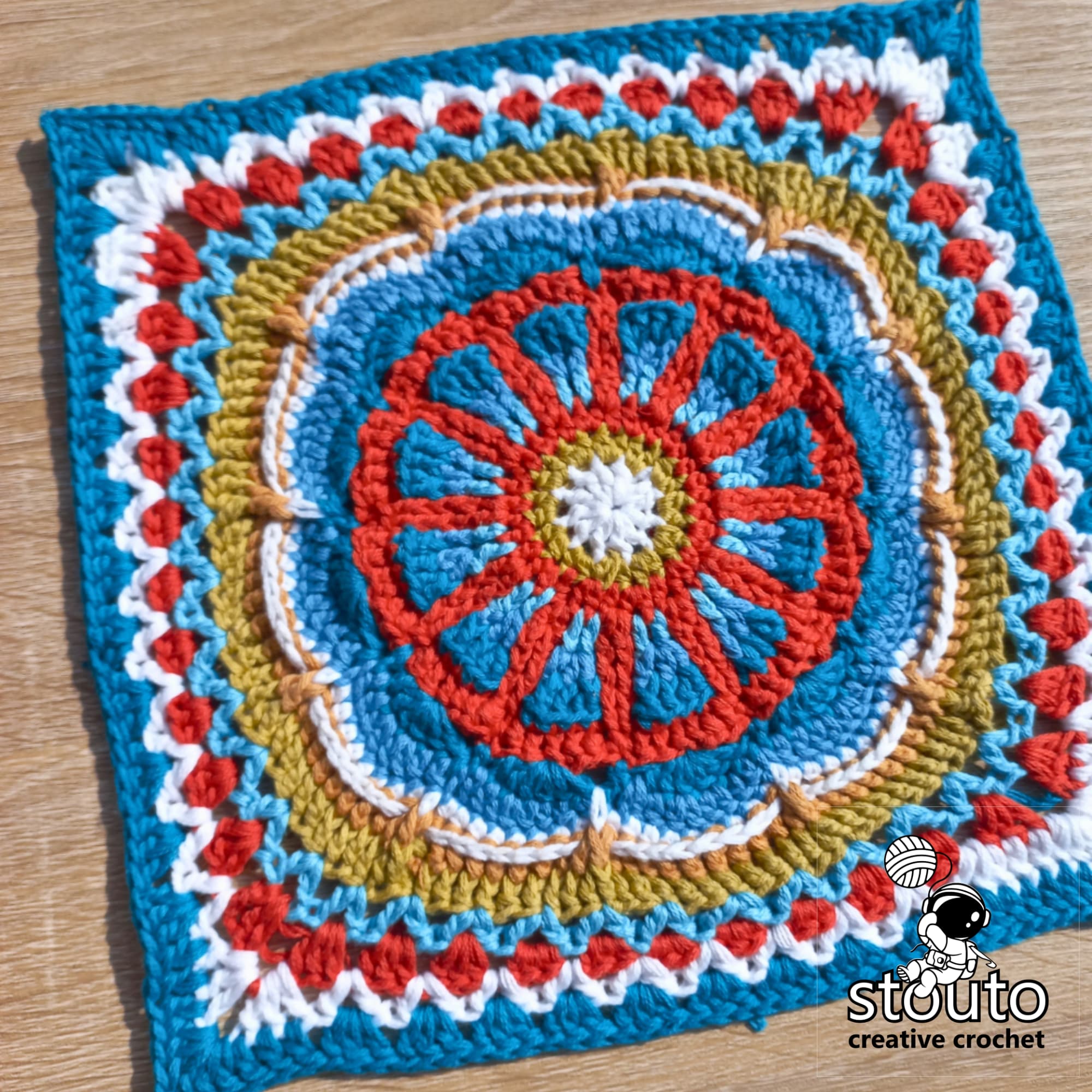 Close-up of the TMBJGF Flower Granny Square showing raised flower petals and textured crochet stitches.