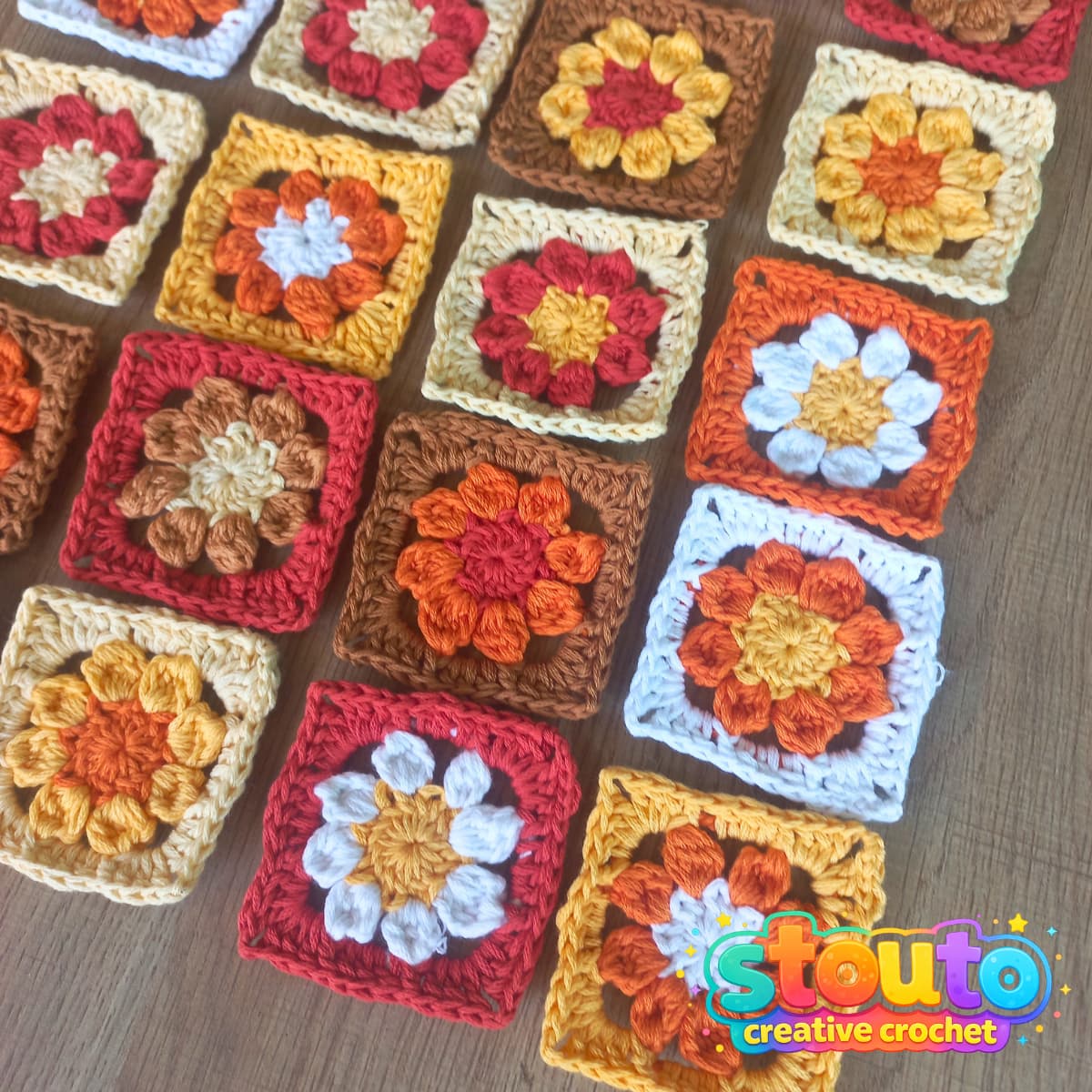 Colourful crochet flower granny squares made in different yarn colours 
