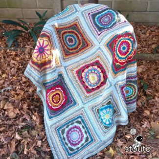 Modern granny square blanket made with textured heirloom flower crochet squares