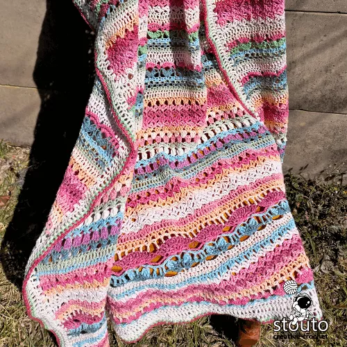 Crochet rose stitch blanket detail highlighting dimensional floral texture