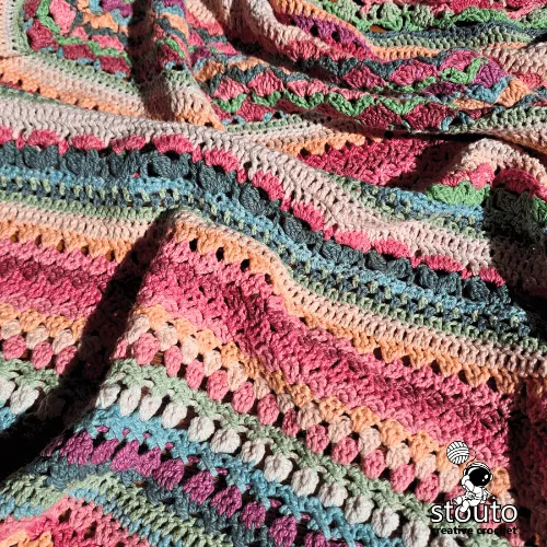 Flower garden crochet blanket pattern combining decorative floral stitches