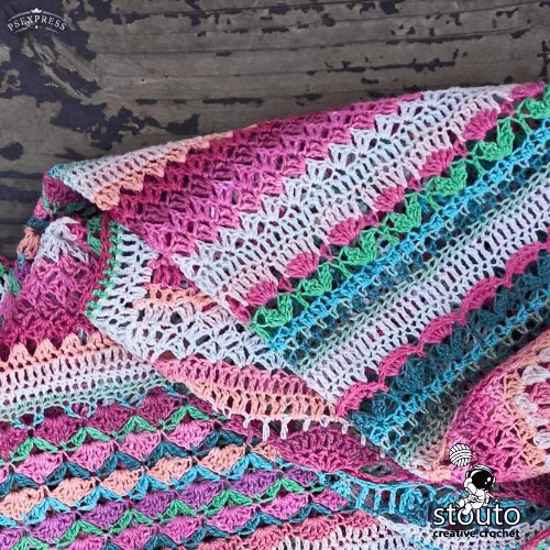 Flower stitch sampler throw crochet blanket featuring multiple floral inspired stitch patterns