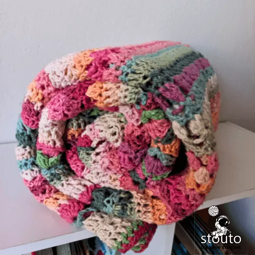 Flower stitch sampler throw crochet blanket featuring multiple floral inspired stitch patterns