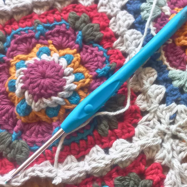 Finished African Cosmos crochet square ready for blanket or cushion project