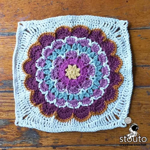Easy free flower granny square crochet pattern with layered petals and detailed photo tutorial.