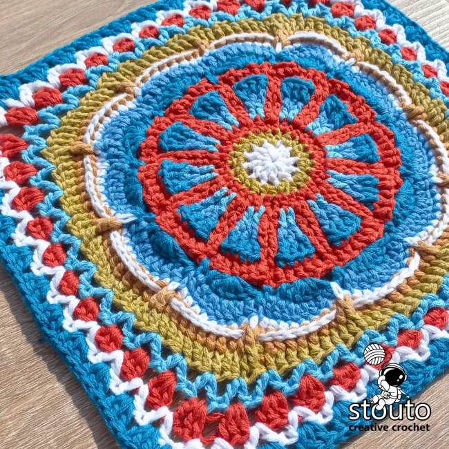TMBJGF Flower Granny Square crochet pattern featuring a textured flower motif and classic granny square finish.