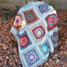 Modern granny square blanket made with textured heirloom flower crochet squares